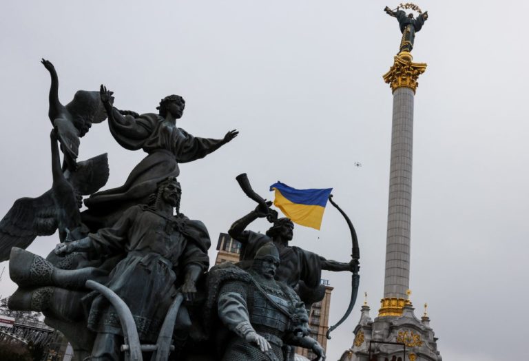 Drone carrying a Ukrainian national flag flies past Independence Monument to mark the Unity Day in Kyiv